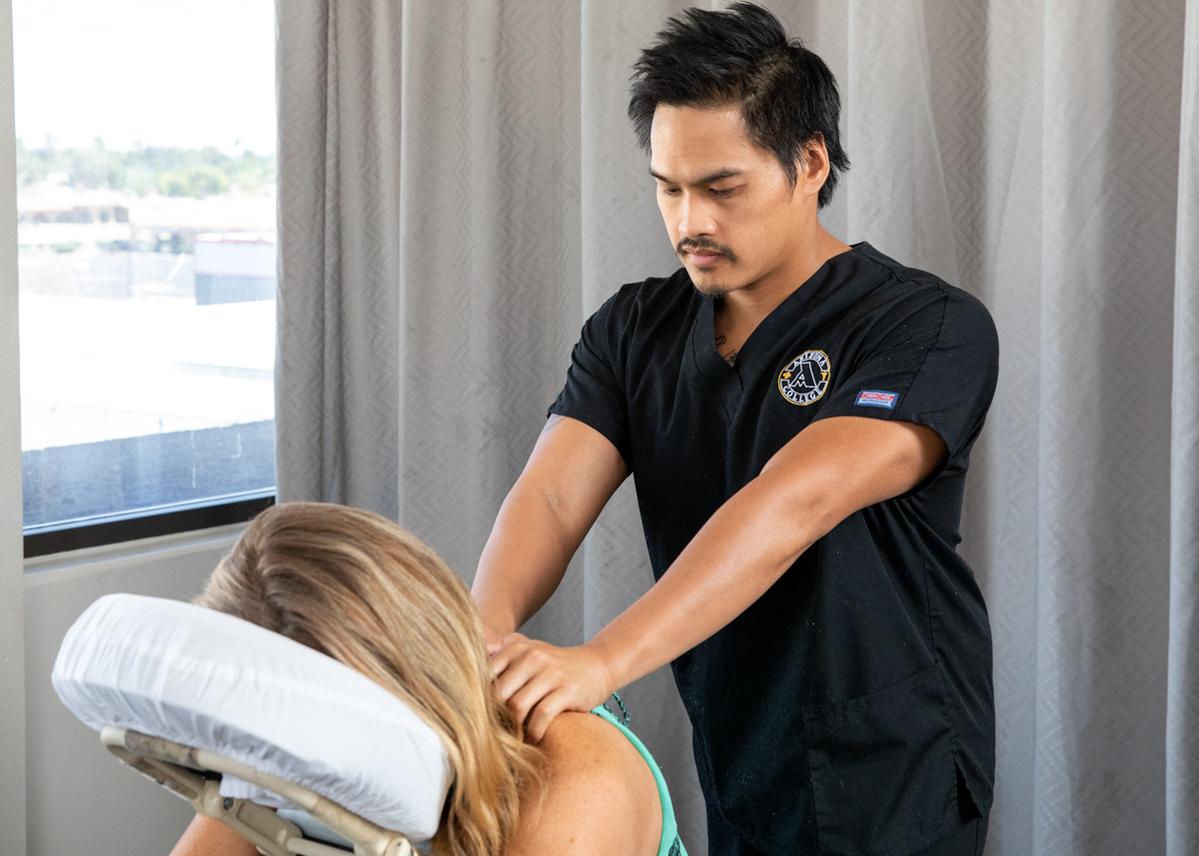 Massage therapy school student practicing at Arizona College