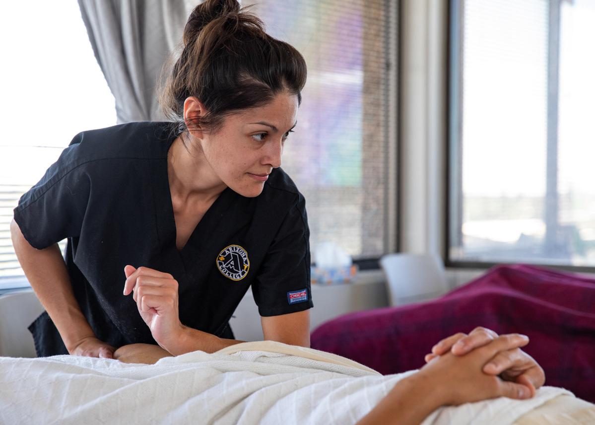 Massage therapy student practicing at Arizona College
