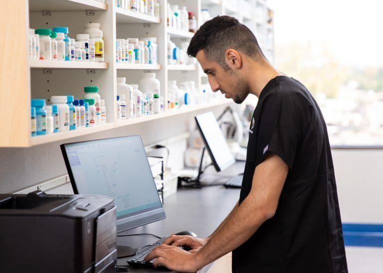 Pharmacy Technician Program student using a computer at Arizona College
