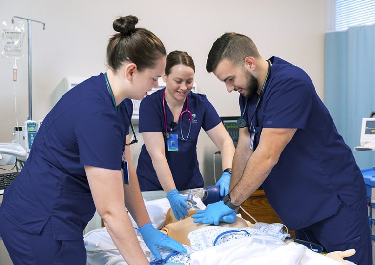 RN School Nursing College Students Applying CPR to Dummy