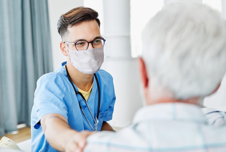 Nurse's assistant communicating with patient.