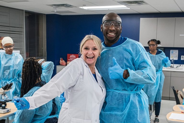 BSN Nursing Program Student With Faculty In Lab Coat