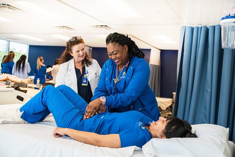 Nursing Degree Student With Teacher On Campus