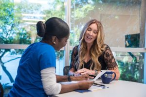 Nursing School Teacher With Student At BSN Nursing Degree Program