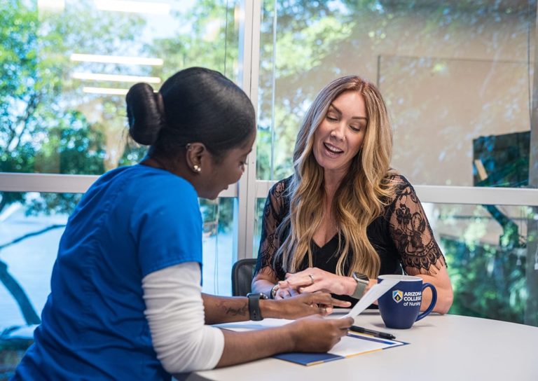 Nursing School Teacher With Student At BSN Nursing Degree Program