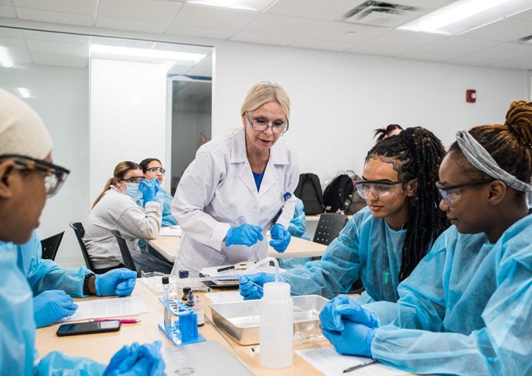 Nursing Program Students and Teacher in lab Coat