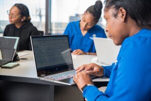 Nursing College student on computer studying for NCLEX Exam