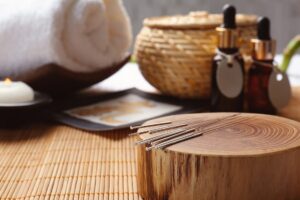 Composition with acupuncture needles on bamboo mat